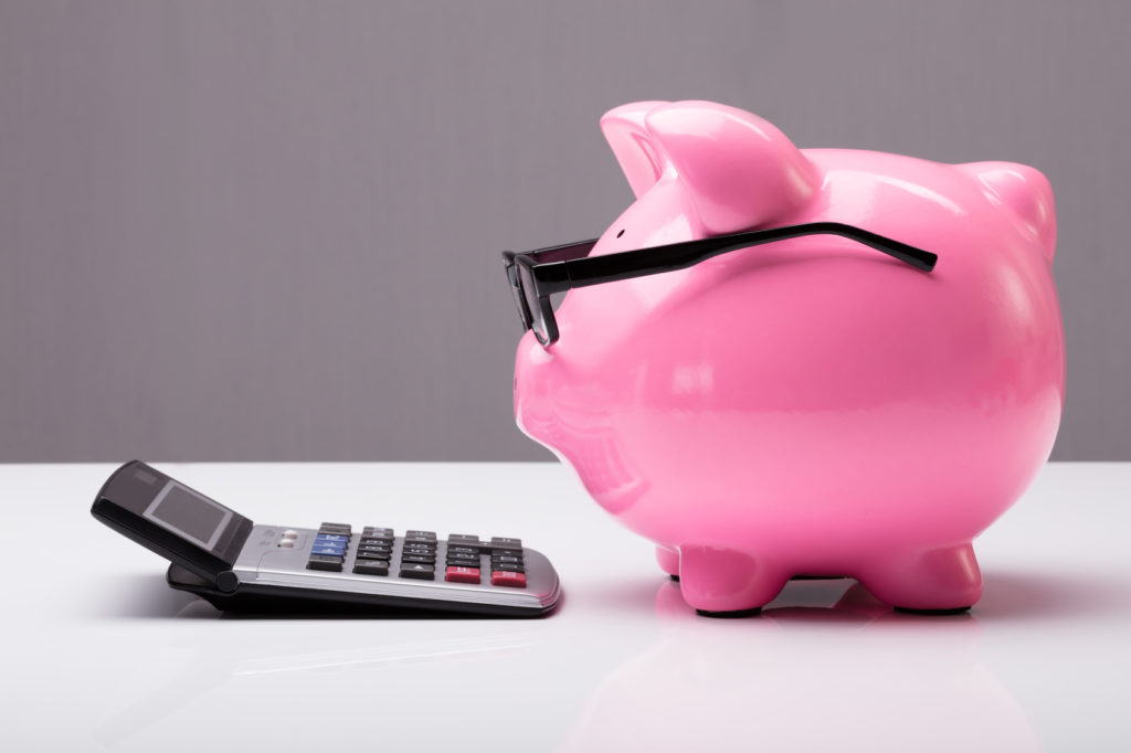 Piggybank With Eyeglasses And Calculator Risparmi